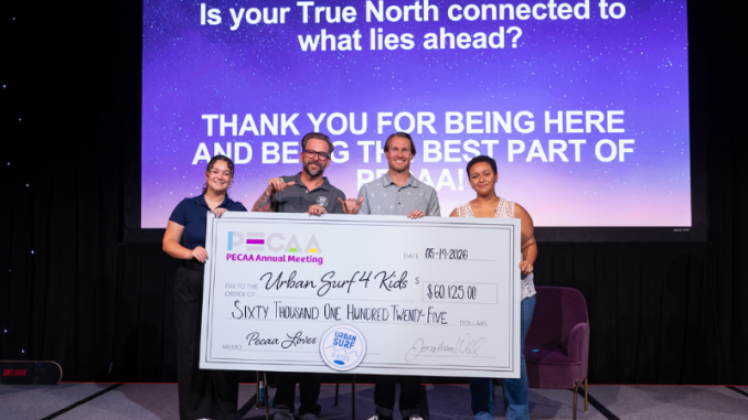 Urban Surf 4 Kids accepting big donation check.