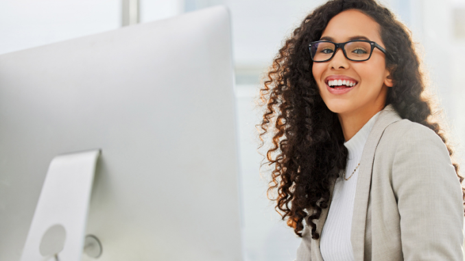 Woman smiling at computer.